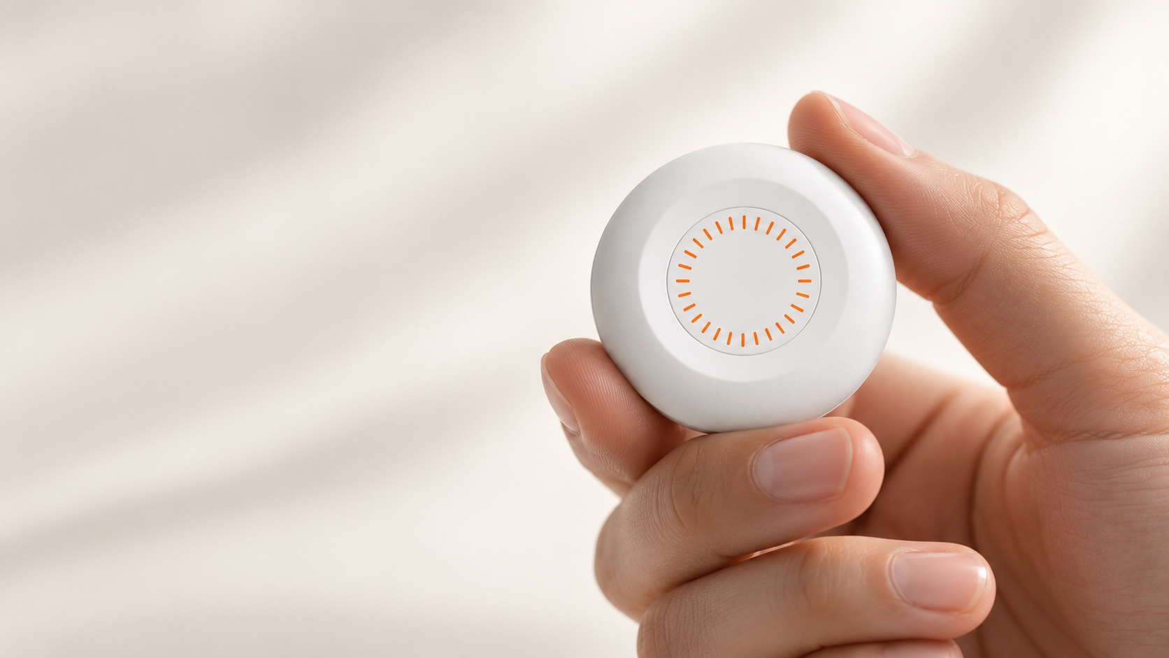 AESISENSE wearable health device held in one hand